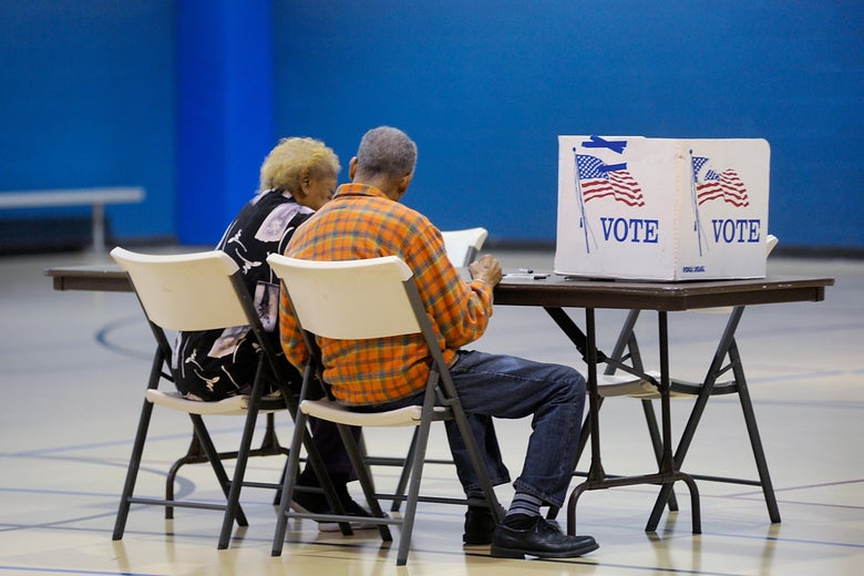 A couple reads a ballot prior to voting on Nov. 8, 2016 in Durham, North Carolina.